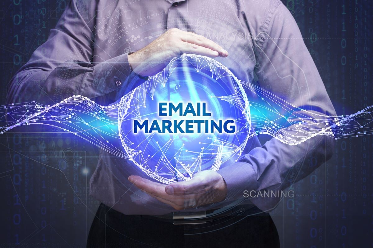 Business, Technology, Internet and network concept. Young businessman shows the word: Email marketing